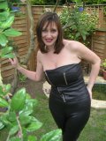 Exhibitionist MILF showing off her classy rack among the trees in her garden
