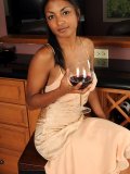Sexy bitch is sitting elegantly with a glass of wine in her hand. Find out how naughty she can be!