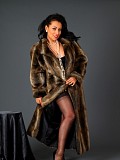 Sexy brunette milf posing in a fur coat and revealing her furry pussy