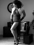 Busty MILF gets rid of her vintage outfit nice and slow on black-and-white pics