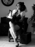 Busty MILF gets rid of her vintage outfit nice and slow on black-and-white pics