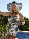 Stunning pictures of a sexy blonde housewife posing by the pool in a hot white corset