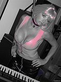Wild slut with sexy pink hair flashes her juicy breasts and strums a guitar