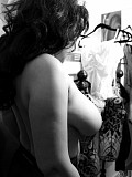 Amazing black and white pictures of a hot milf trying on sexy lingerie and flashing her tits