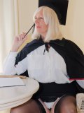 Mature porn star pretending to be a naughty college graduate in black stockings