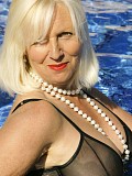 Ravishing slutty mature blonde posing in seductive black lingerie by the pool