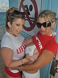 Two amazing cougars dressed as lifeguards flash their tits at a public beach